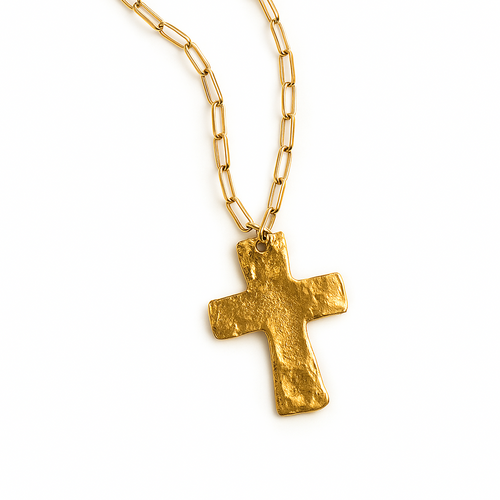 Gold cross necklace on a white background
