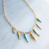 Desert Tide Necklace – Gold Chain with Playful Fish Charms