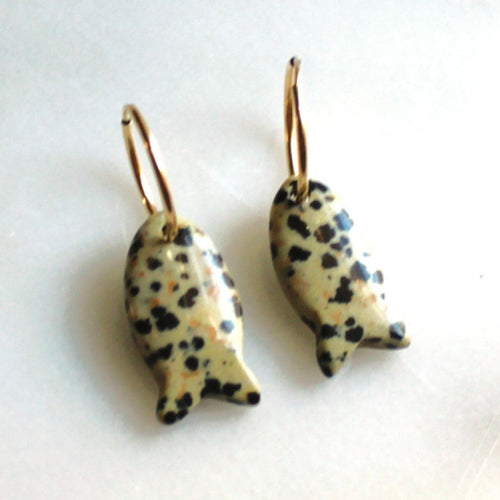 Pair of fish-shaped earrings with a spotted pattern on a white background