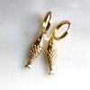 Gold fish-shaped earrings on a white background