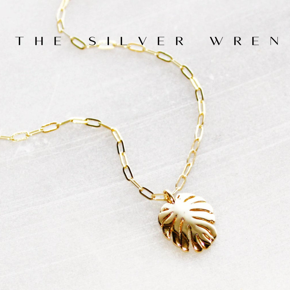 Gold chain necklace with a shell pendant on a white background, branded 'The Silver Wren'.